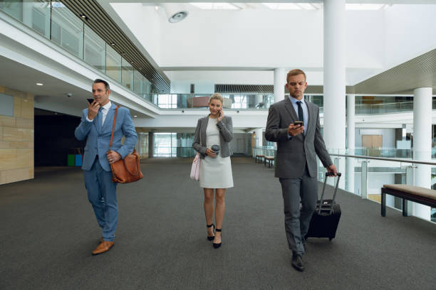 istock Business people talking on mobile phone while walking in the corridor 1166426062
