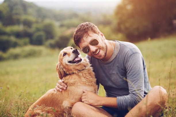 istock Guy and his dog having a fun in the nature 1166426079