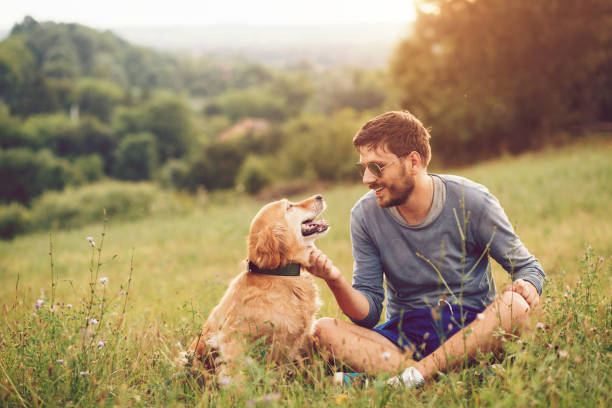 istock Guy and his dog having a fun in the nature 1166429002