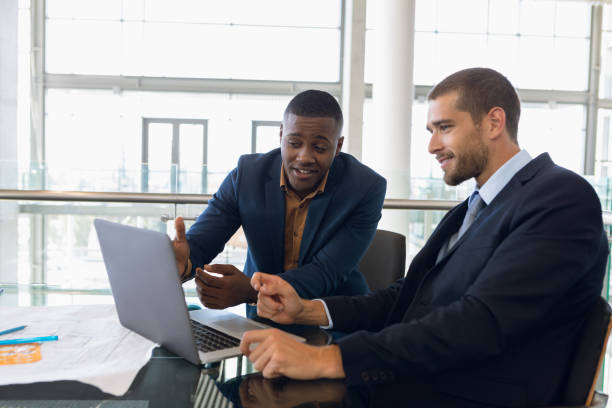 istock Two young businessmen working together 1166429620