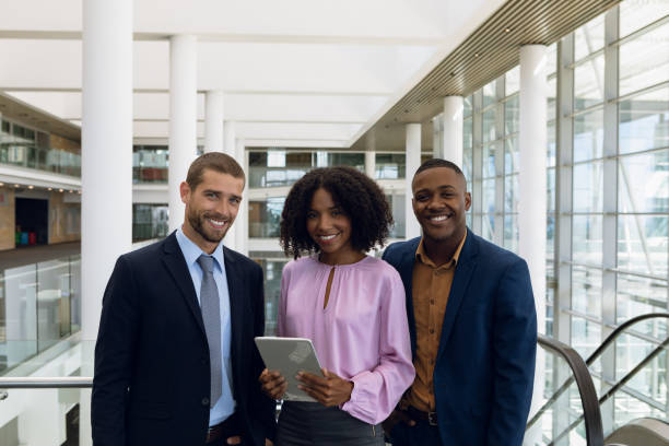istock Diverse young business people standing in modern office lobby 1166429686