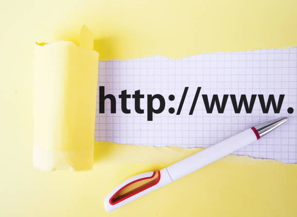 istock concept. web address behind Tear yellow Paper and pencil 1166430057