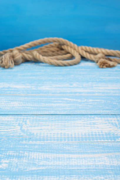 istock ship rope at wooden board background 1166430218