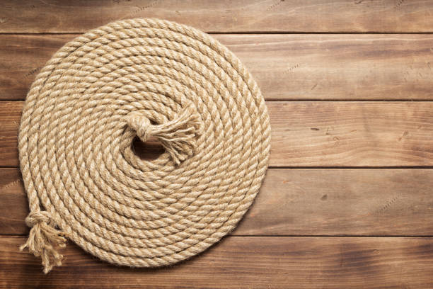 istock ship rope at wooden board background 1166431922