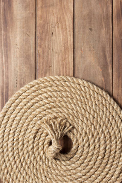 istock ship rope at wooden board background 1166431930