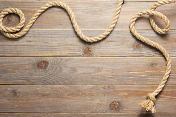 istock ship rope at wooden board background 1166431981