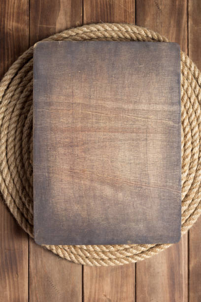 istock ship rope at wooden board background 1166432141