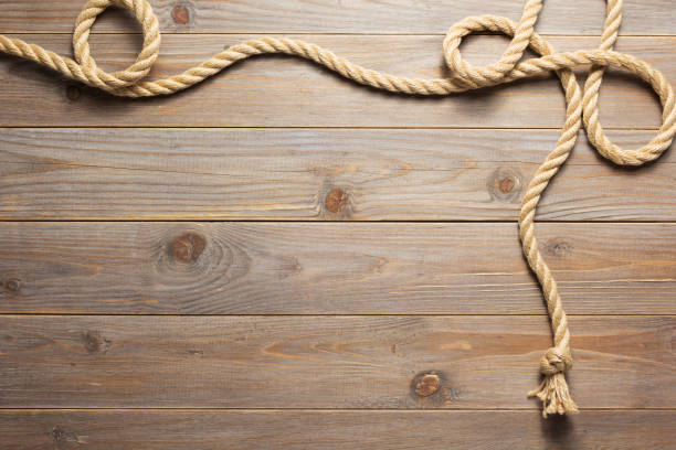 istock ship rope at wooden board background 1166432172