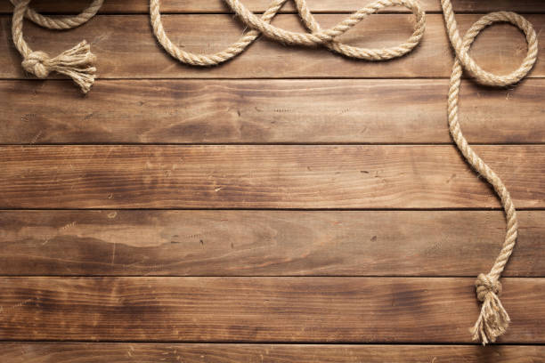 istock ship rope at wooden board background 1166432210