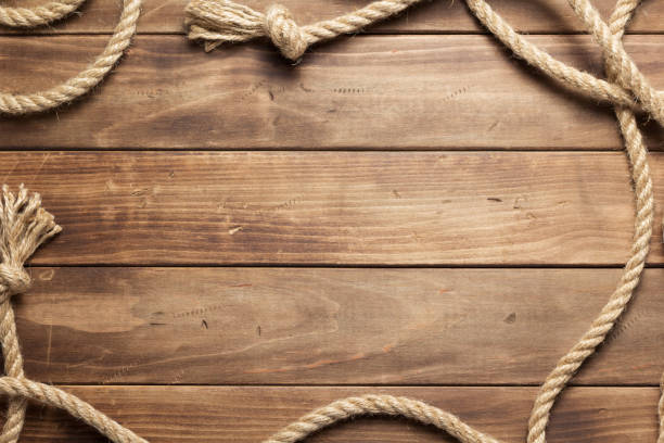 istock ship rope at wooden board background 1166432228
