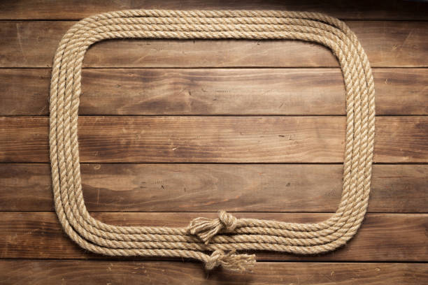 istock ship rope at wooden board background 1166432307