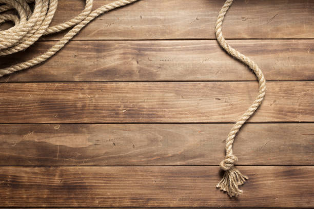 istock ship rope at wooden board background 1166432316