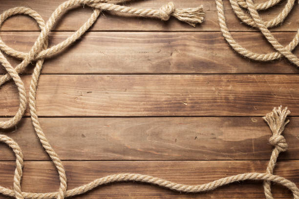 istock ship rope at wooden board background 1166432319