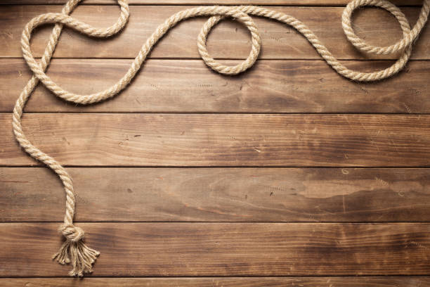 istock ship rope at wooden board background 1166432325