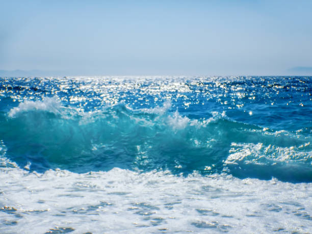 istock Breaking Wave of Blue Ocean on sandy beach Summer Background 1166433021