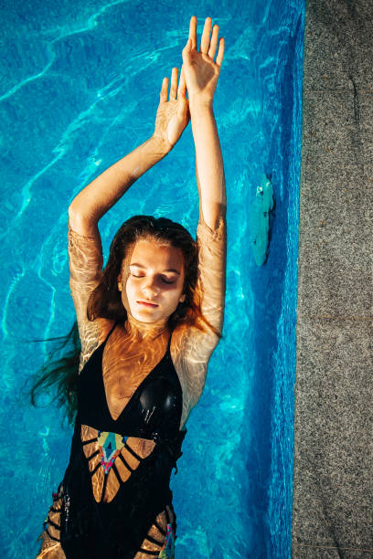istock Woman Floating at Swimming Pool 1166434829