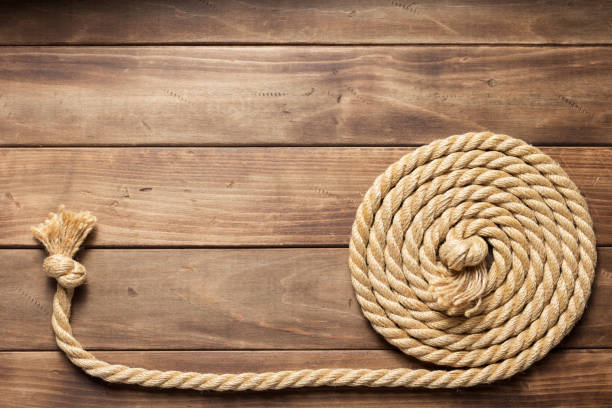 istock ship rope at wooden board background 1166434850