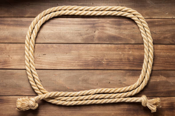 istock ship rope at wooden board background 1166435028