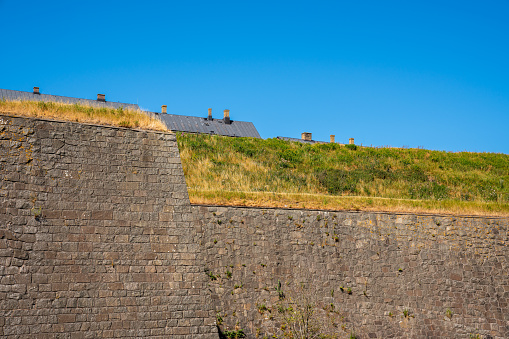 Beautiful summer landscape with a historic and old massive medieval defense wall at Varbergs Fortress in Sweden. Horizontal composition.