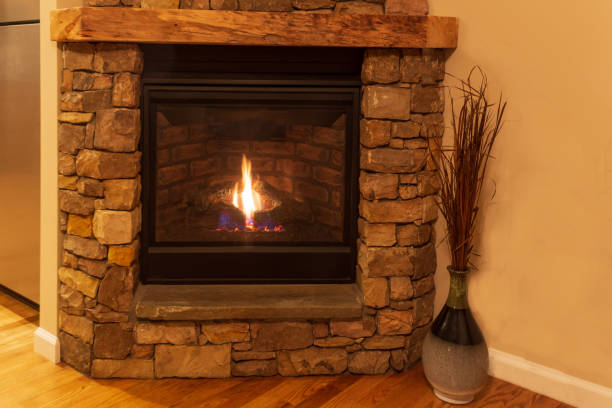 istock Brown stone fireplace in a residential home. 1166436250