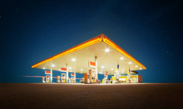 Gas station Unbranded Gas station with retail convenience store at night time . station stock pictures, royalty-free photos & images