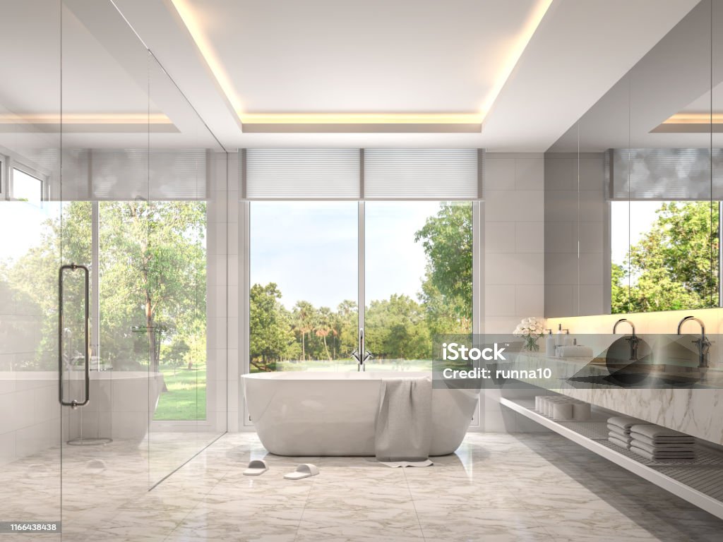 Modern luxury white bathroom with garden view 3d render Modern luxury white bathroom 3d render. Room with marble tile floors. There is a glass shower wall. With large windows overlooking the nature Bathroom Stock Photo