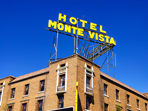 Flagstaff Arizona, USA, May 25 2019. Monte Vista hotel old fashioned building facade with red bricks, clear blue sky background. U.S. Route 66.