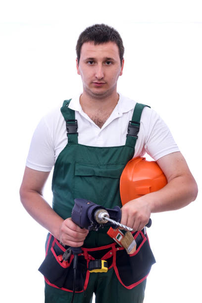istock Worker with drill machine and supplies isolated on white 1166439119