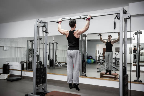 istock Man making some exercises on crossbar at gym 1166439401