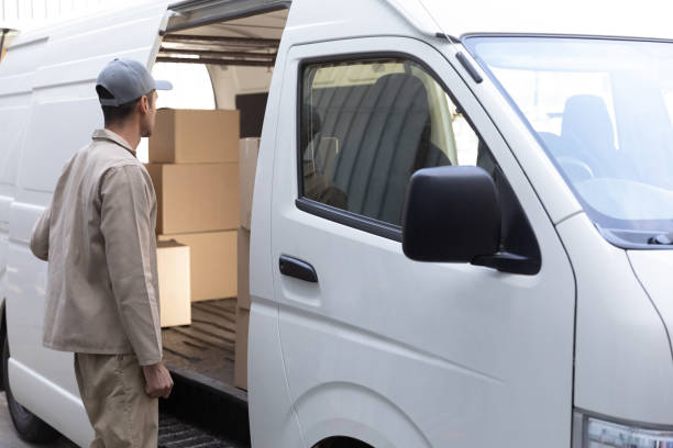 istock Delivery man standing near van outside the warehouse 1166439462