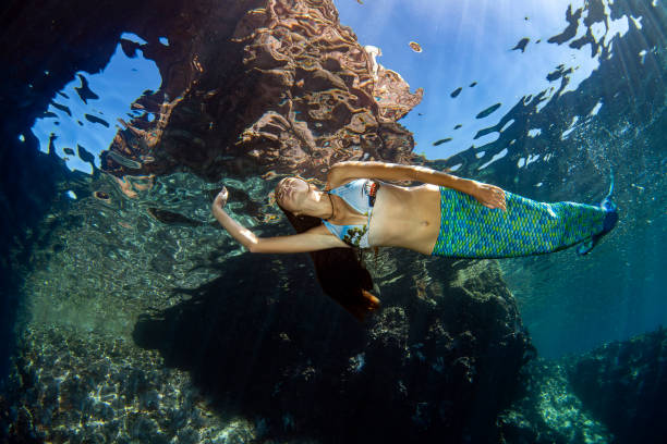 istock Mermaid swimming underwater in the deep blue sea 1166441033