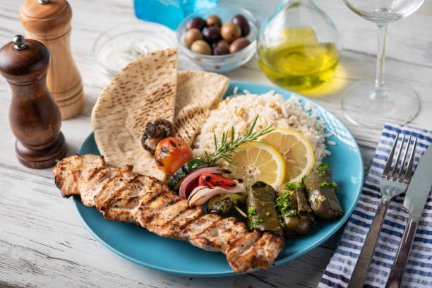 assorted greek food platter with souvlaki, rice, pita and dolmades - opa! souvlaki of greece imagens e fotografias de stock