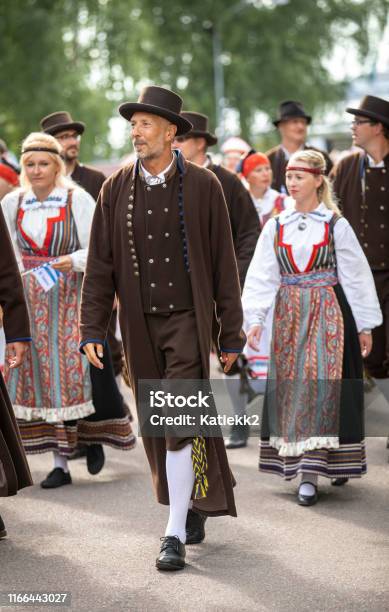 Estonian People In Traditional Clothing Walking The Streets Of Tallinn Stock Photo - Download Image Now