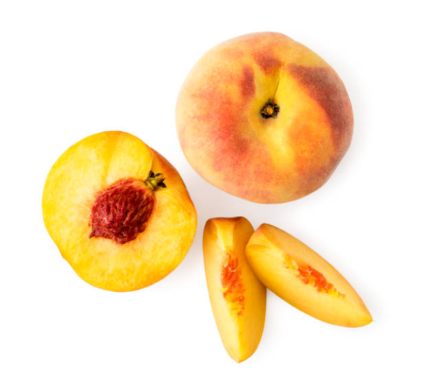 istock Peach, half with a bone and two pieces on a white. The view of the top. 1166445119