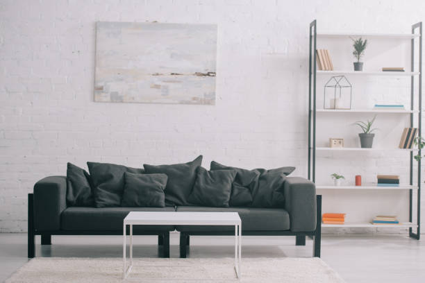 istock black sofa near coffee table and rack in modern living room 1166445378