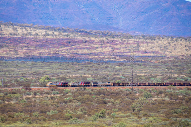 istock Long train at Karijini National Park transporting iron ore from Marandoo Mine Site towards coast 1166445686