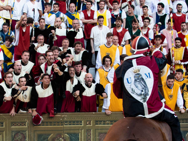 A group of fanatical fans encourage the jockey representing their contrade (neigbhoood) during the Palio in Siena, Italy stock photo