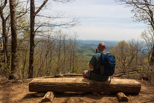 Male hiker taking in the view of the Chattahoochee National Forest in Georgia from the five-mile trail to Hike Inn.