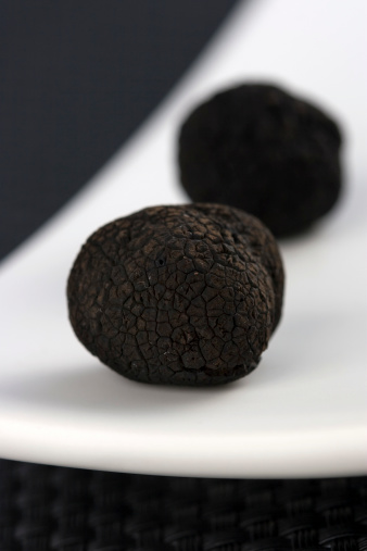 Two black raw truffles.