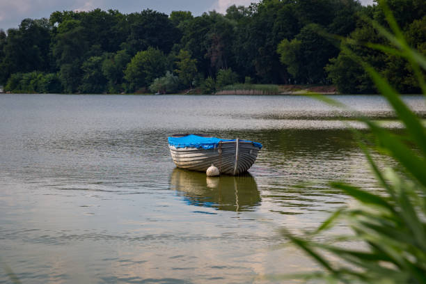 istock lonely boat on the river on a sunny day 1166446979