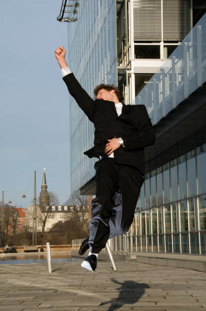istock Joyful businessman jumps in the air 116644962