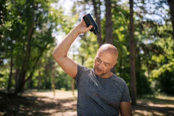 istock Tired running man refreshing with water in the forest 1166450970