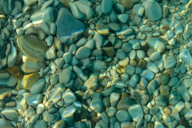 istock Blurred natural background. Pebbles through the clear sea water. 1166452017