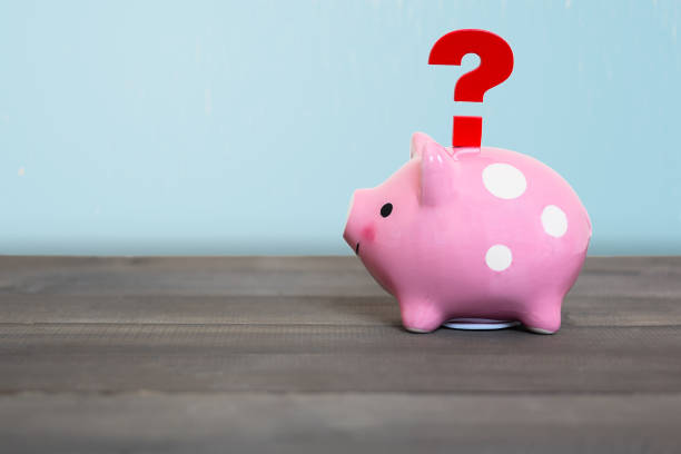 istock Question mark with piggy bank on wood table , Problem Concept 1166459747