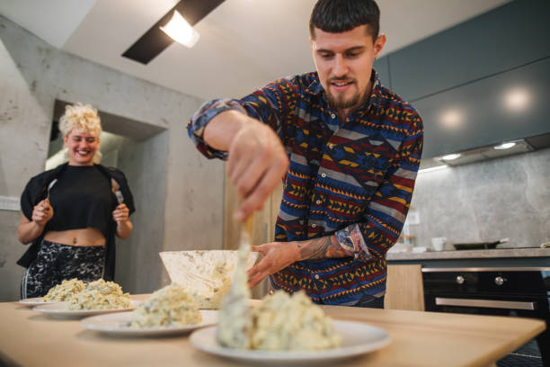 istock Cooking couple preparing pasta for a dinner party 1166461435