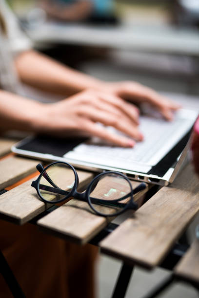 istock Eye glasses on a busy woman's table in cafe. 1166461455