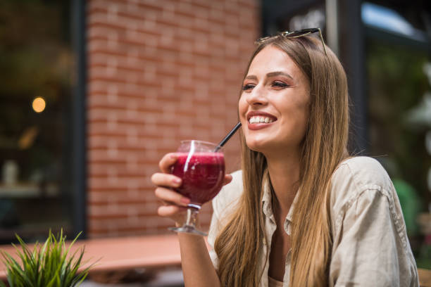 istock Charming young woman enjoying a smoothie. 1166461470