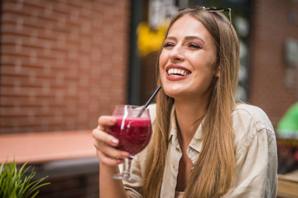 istock Young charming woman drinking a smoothie. 1166461803