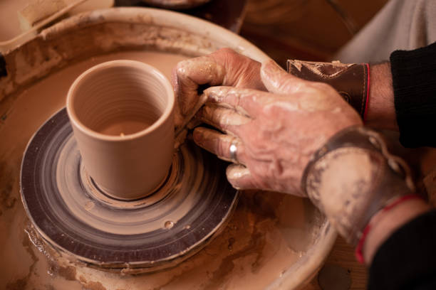 istock men's hands work with clay, turning it into a product 1166465979