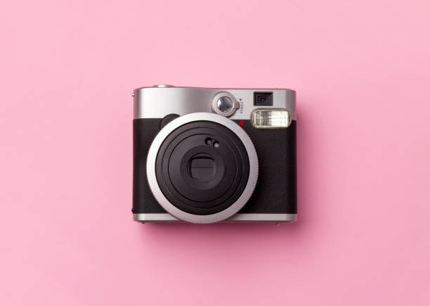 istock Vintage instant camera at pastel pink background. 1166466313